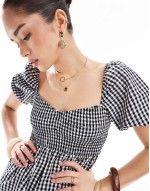 Exclusive mini puff sve beach dress in black and white gingham